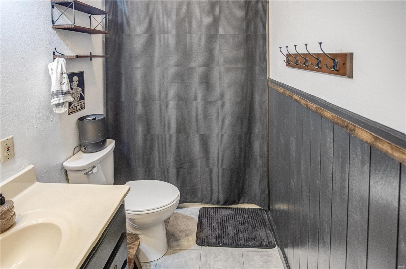 Bathroom with vanity, tile patterned floors, and toilet