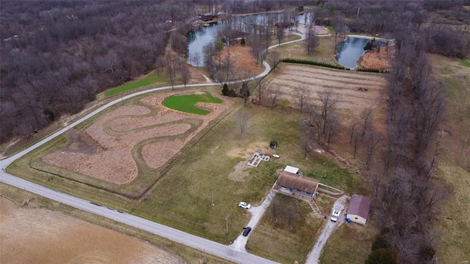 Birds eye view of property with a water view