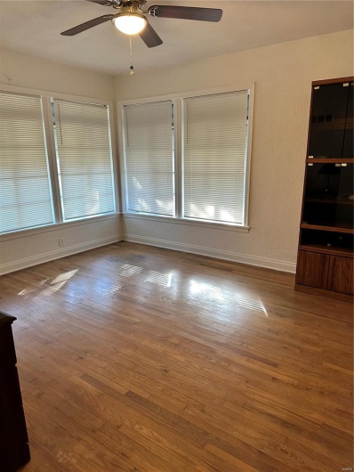 Unfurnished room with ceiling fan and wood-type flooring