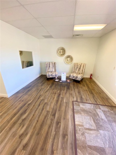 Unfurnished room with a drop ceiling and wood-type flooring