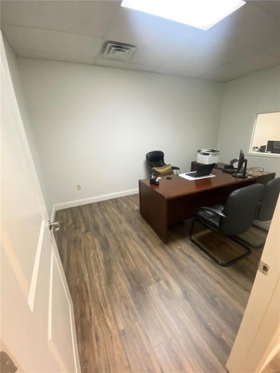Office featuring a drop ceiling and dark hardwood / wood-style floors