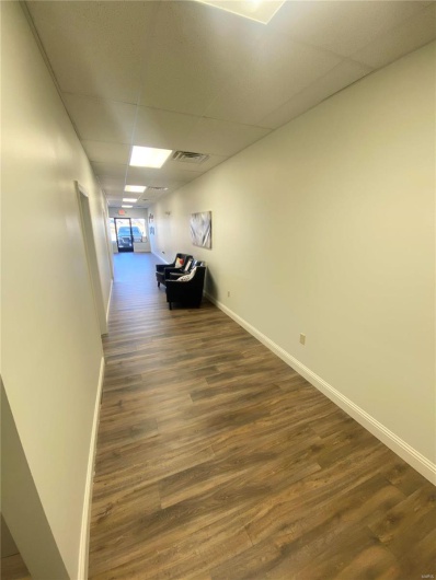 Hall featuring a drop ceiling and dark hardwood / wood-style floors