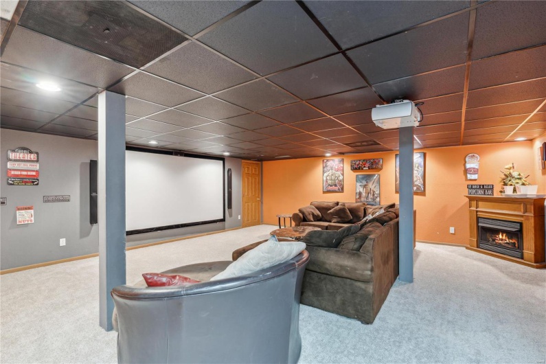 Cozy home theater room with fireplace.