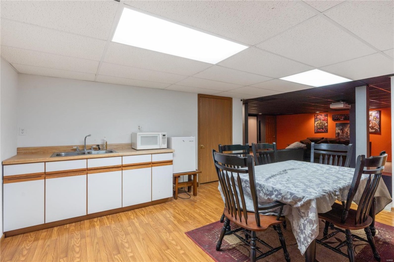Kitchenette/Dining space, sink, and a drop ceiling in lower level