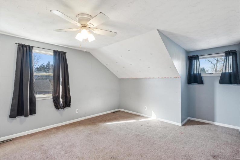 Additional living space with ceiling fan, bedroom or bonus room.