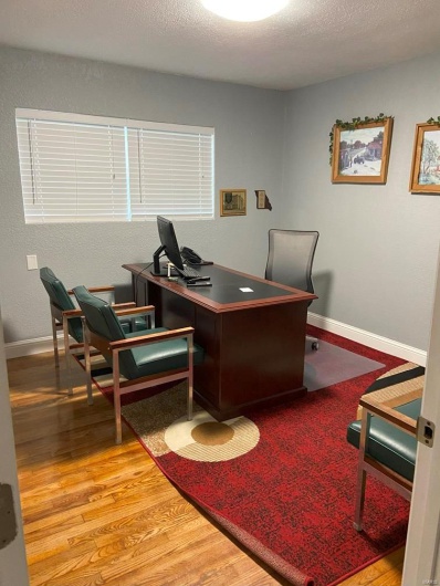 Office featuring light hardwood / wood-style floors and a textured ceiling