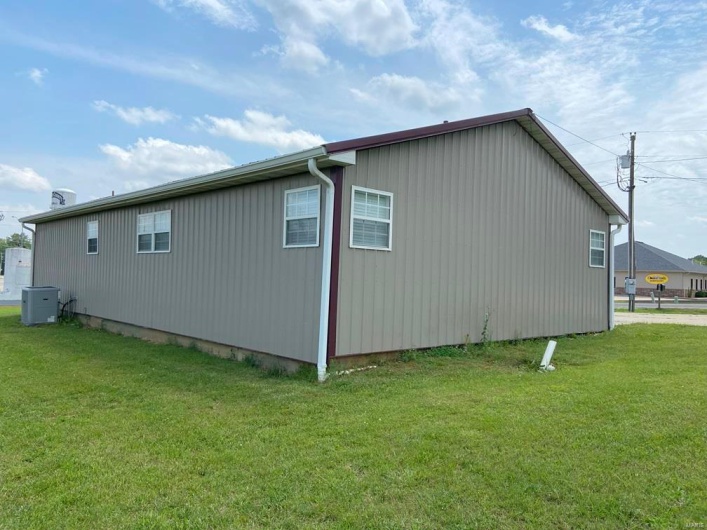 View of side of property with a yard