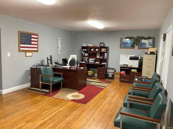 Reception area with wood-type flooring and a textured ceiling