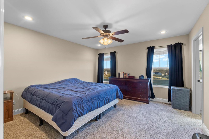Carpeted bedroom with ceiling fan