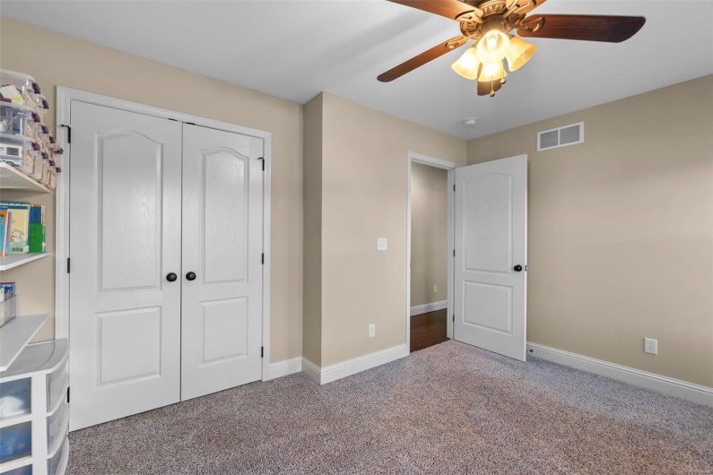 Unfurnished bedroom with light colored carpet, a closet, and ceiling fan