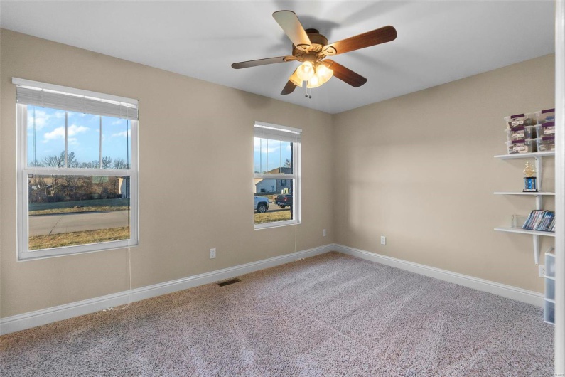 Carpeted empty room with ceiling fan