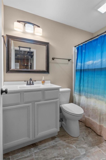 Bathroom with vanity, toilet, and walk in shower