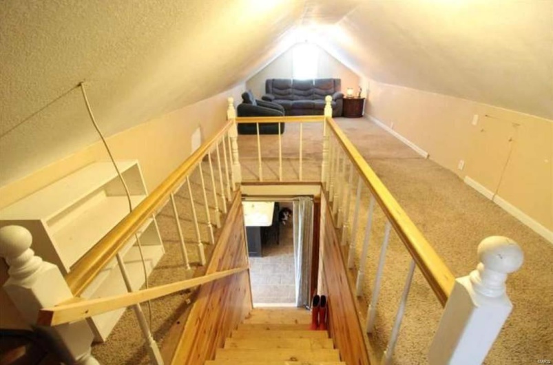 Stairs featuring hardwood / wood-style flooring and vaulted ceiling