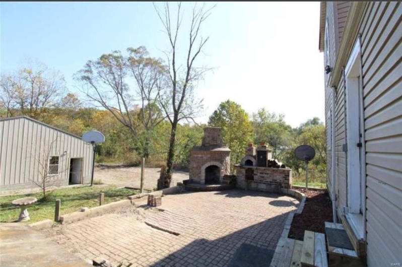 View of patio / terrace with an outdoor stone fireplace