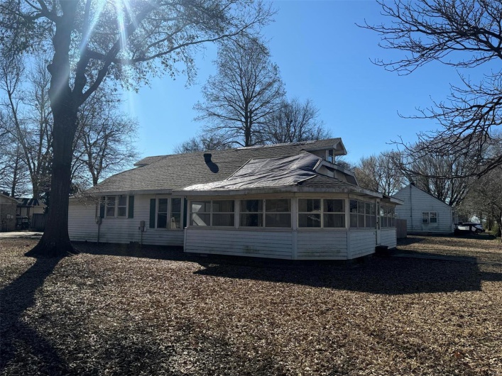 Back of house featuring a sunroom