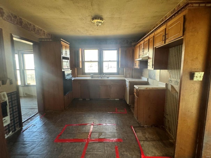 Kitchen with stainless steel microwave, oven, sink, and heating unit