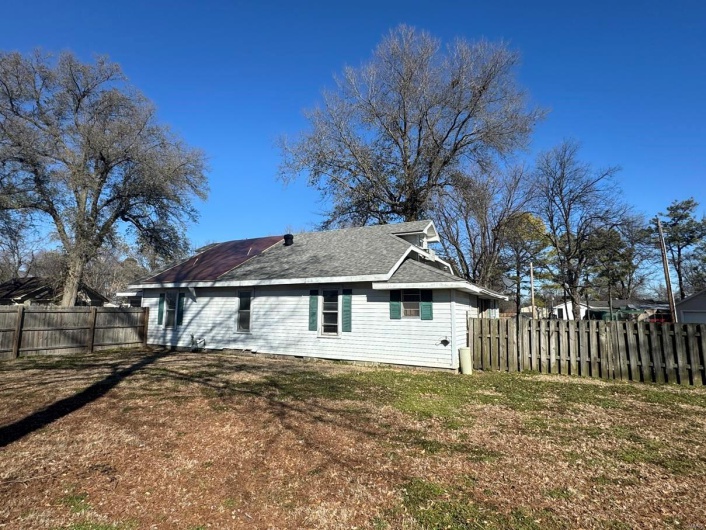 Rear view of property with a lawn