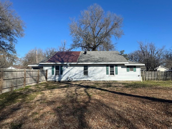 Back of house featuring a lawn