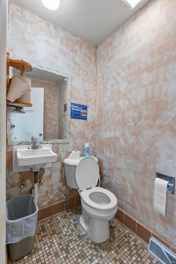 Bathroom with tile patterned flooring, sink, and toilet