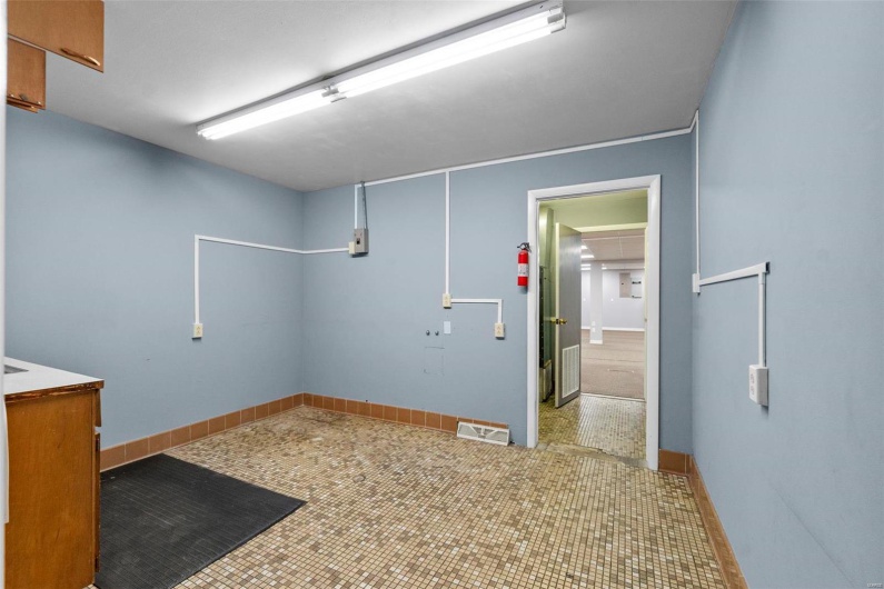 Washroom with light tile patterned flooring