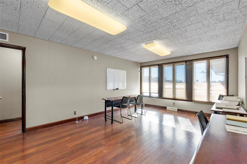Home office featuring a healthy amount of sunlight and dark hardwood / wood-style flooring
