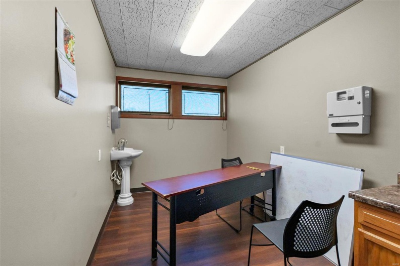 Office area with dark hardwood / wood-style floors