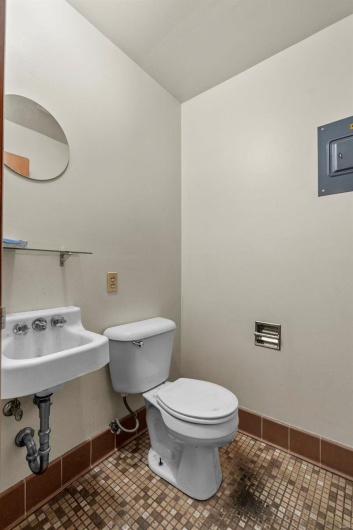 Bathroom with tile patterned flooring, sink, and toilet