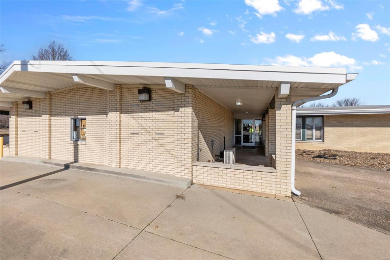 View of parking with a carport