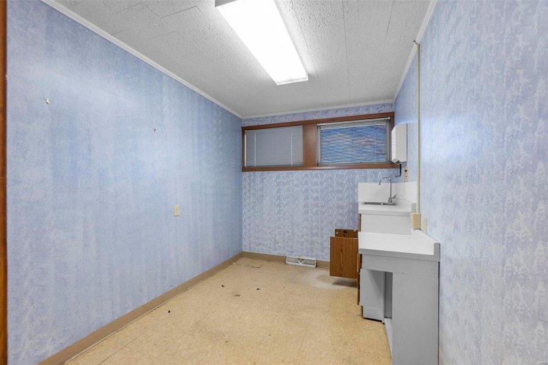 Basement featuring crown molding