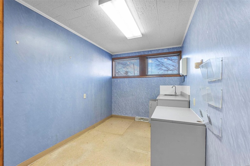 Clothes washing area with ornamental molding and washer / clothes dryer