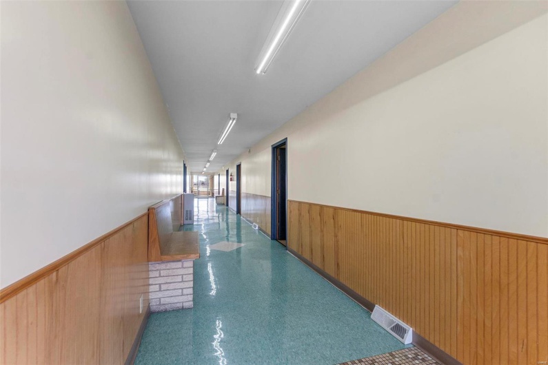 Hall featuring wooden walls
