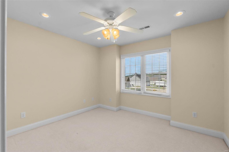 Spare room with light carpet and ceiling fan