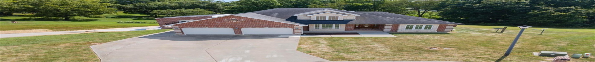 Residential For Sale View of front of property with a garage and a front lawn