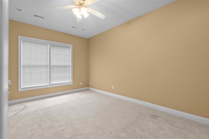 Carpeted spare room with ceiling fan