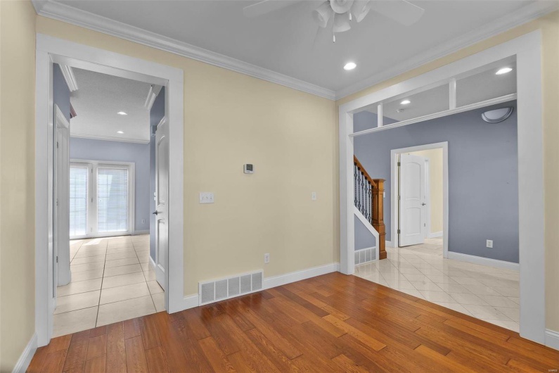 Spare room featuring ceiling fan, ornamental molding, and light hardwood / wood-style floors