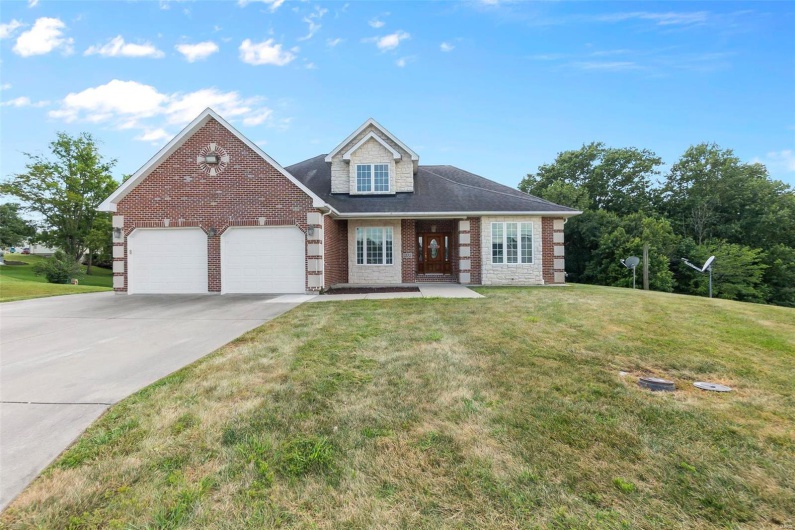 View of front of property featuring a garage and a front yard