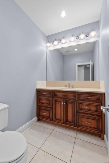 Bathroom featuring vanity, tile patterned floors, and toilet