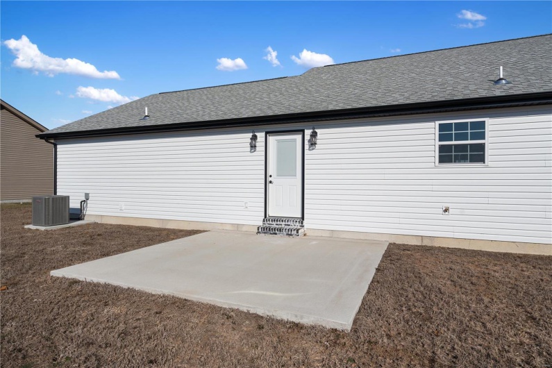 Back of property featuring central AC unit and a patio area