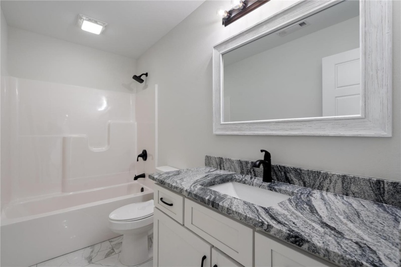 Full bathroom with vanity, toilet, and shower / bathing tub combination