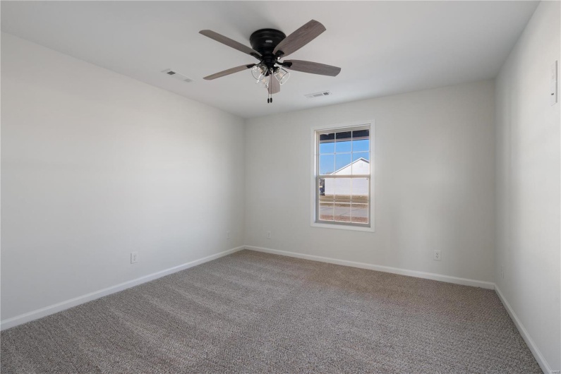 Spare room featuring carpet floors and ceiling fan