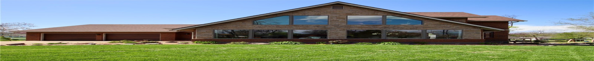 Residential For Sale View of front facade with an attached garage, driveway, a front yard, and stone siding
