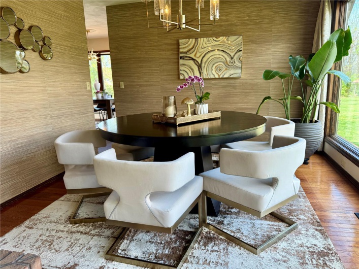 Dining area with wood finished floors, an inviting chandelier, and baseboards