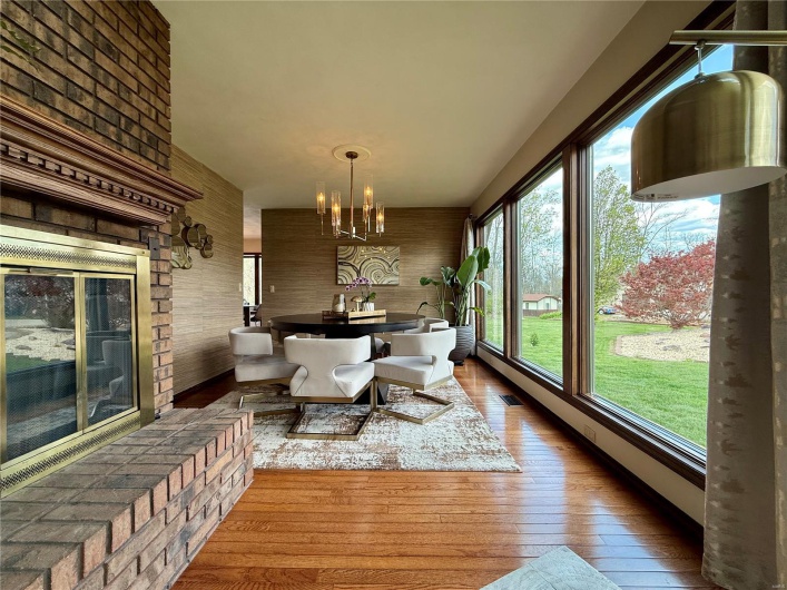 Dining room featuring wood walls, an inviting chandelier, wood-type flooring, and visible vents