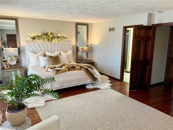 Bedroom with dark hardwood / wood-style floors and a textured ceiling