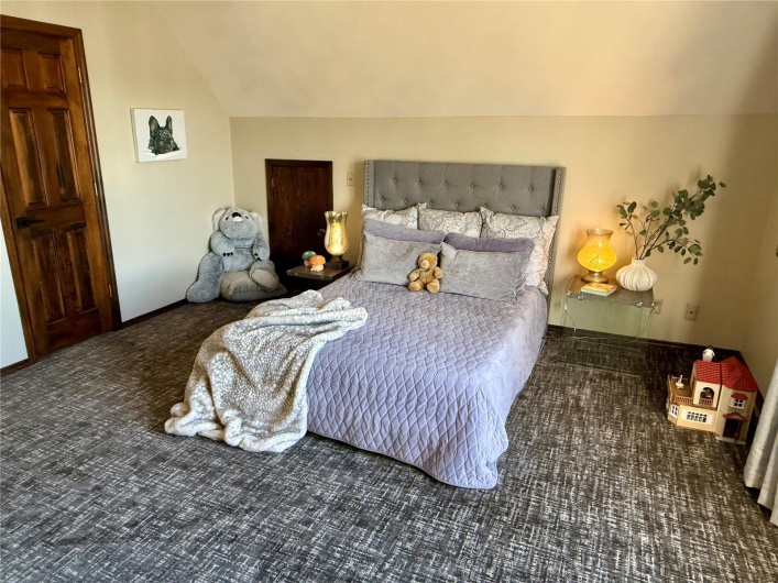 Bedroom featuring lofted ceiling
