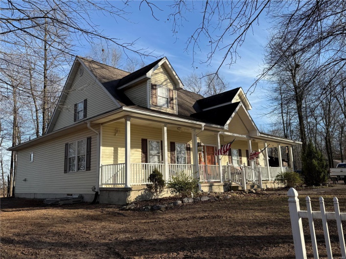 Farmhouse featuring a porch
