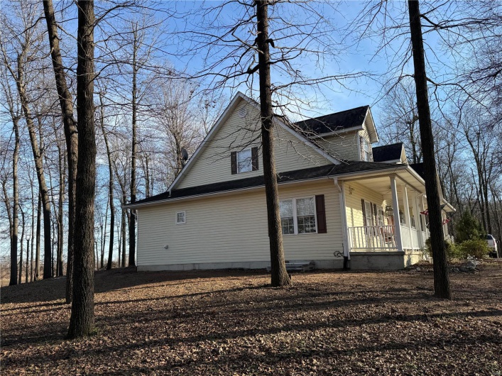 View of side of property with a porch