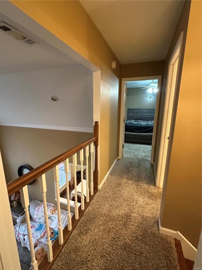 Corridor featuring carpet floors