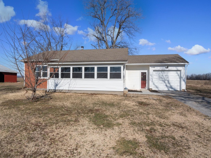 Ranch-style home with a garage and a front yard