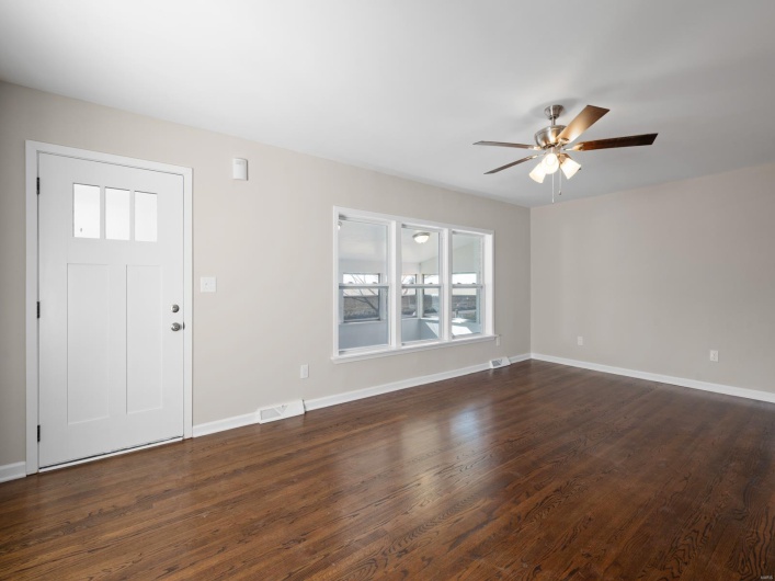 Entryway with dark hardwood / wood-style floors and ceiling fan
